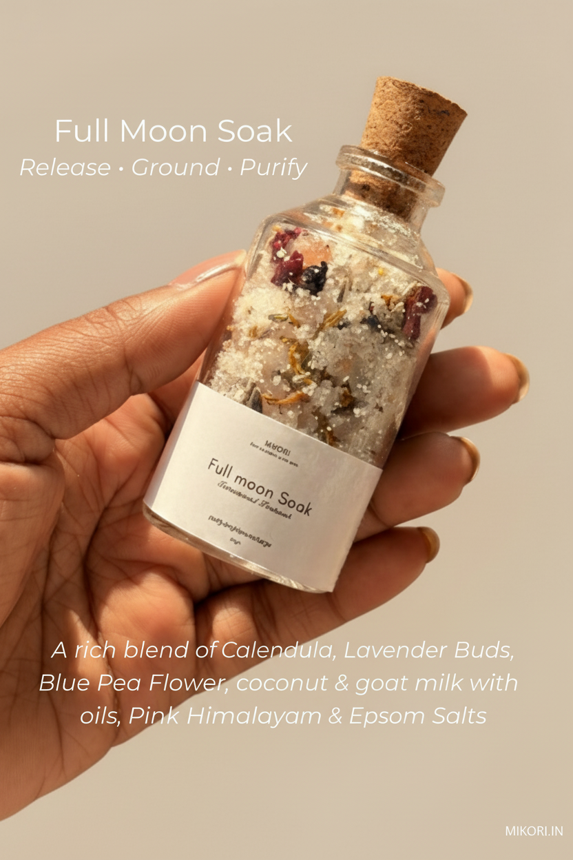 Hand holding a bottle labeled 'Full Moon Soak' with ingredients listed on a neutral background